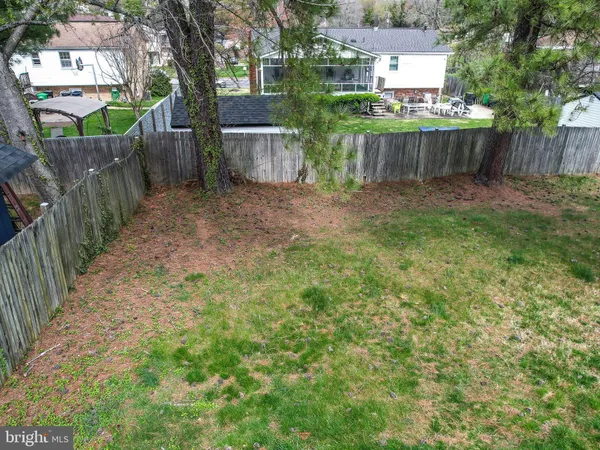 a view of a house with a yard and a fence