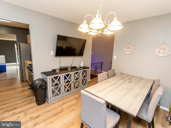 a view of a dining room with furniture and a flat screen tv