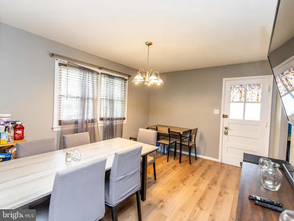 a dining room with a table chairs and entryway