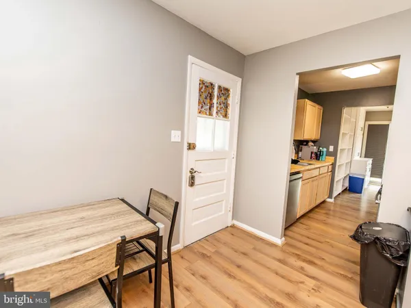 a workspace with wooden floor and furniture