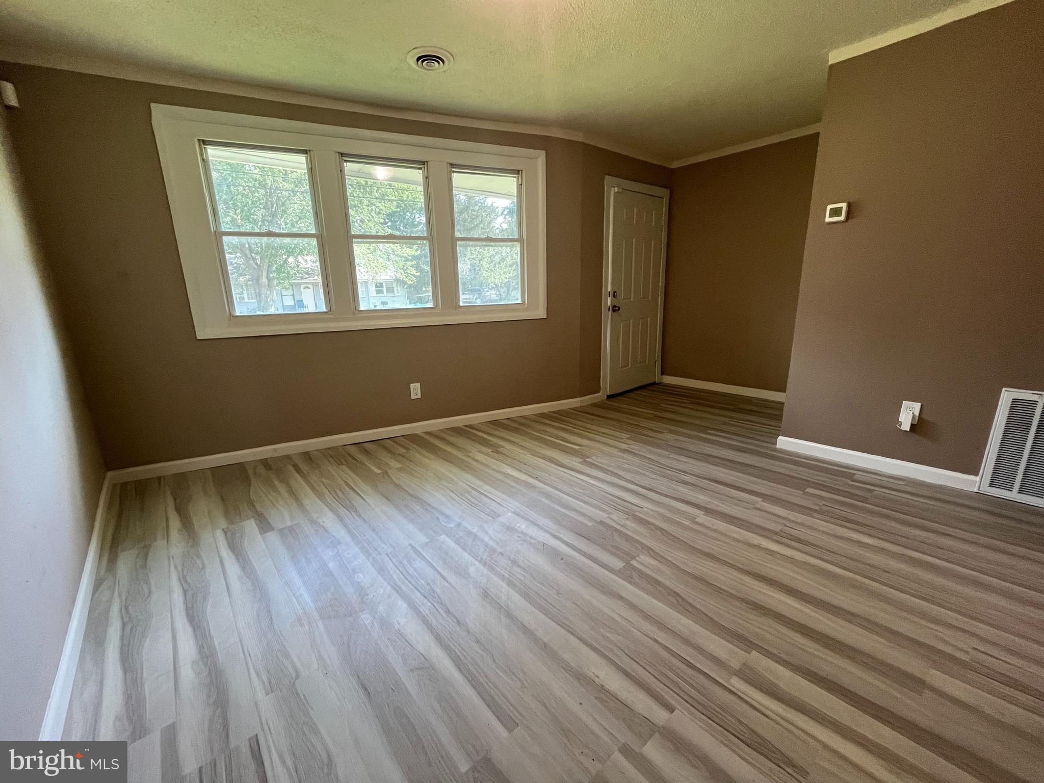 112 Kinsley Road Pemberton, NJ 08068 - Photo 9 of 13 a view of an empty room with wooden floor and a window