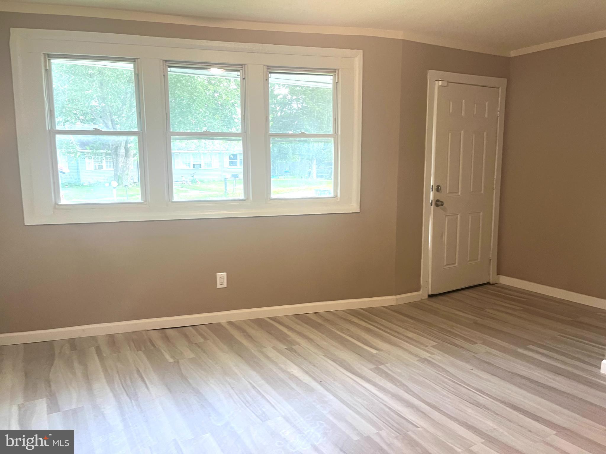 112 Kinsley Road Pemberton, NJ 08068 - Photo 10 of 13 a view of an empty room with wooden floor and a window