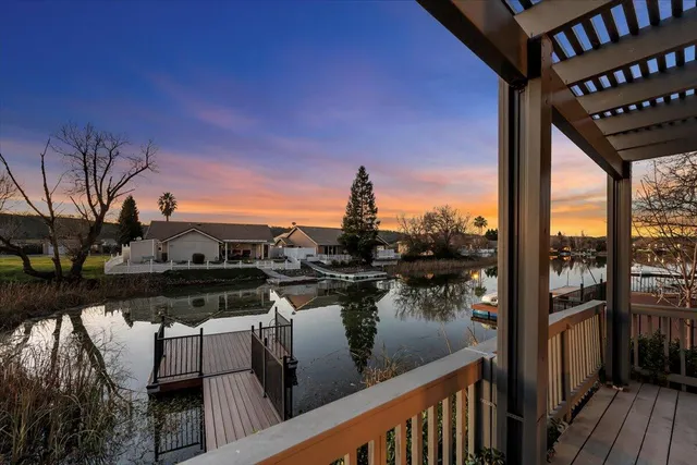 a view of a balcony with chairs and wooden floor