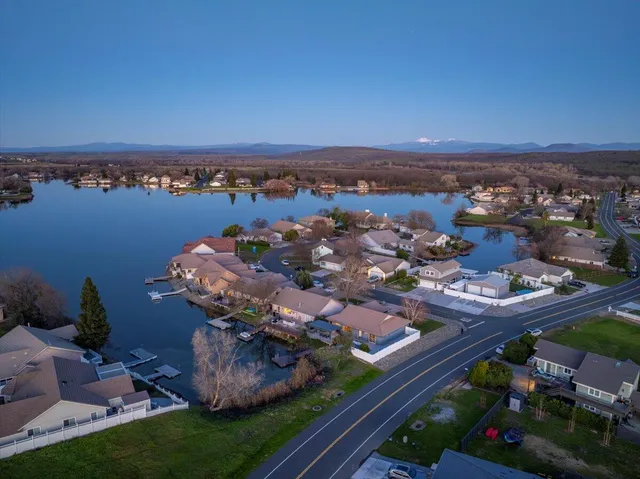 an aerial view of a house with a lake view
