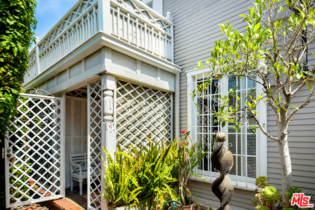 8954 1/2 Norma Place West Hollywood, CA 90069 - Photo 2 of 14 a yellow building with a trees in front of it