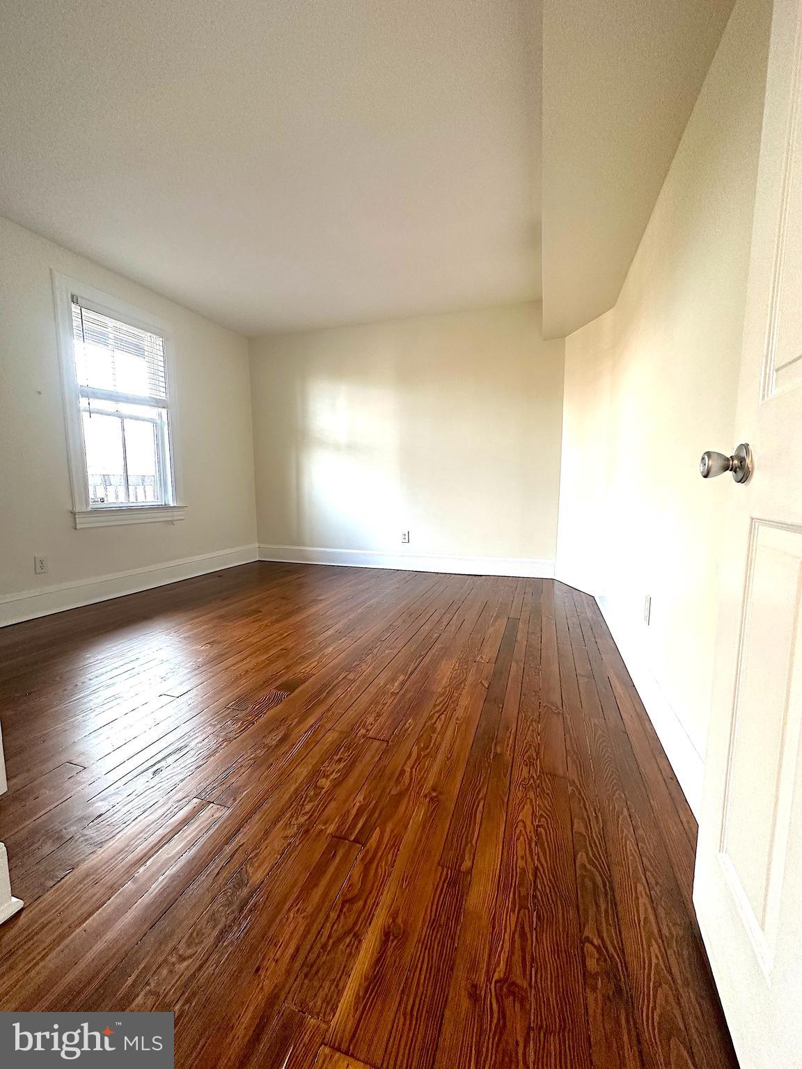1133 D Street Northeast, Unit 2A Washington, DC 20002 - Photo 5 of 14 an empty room with wooden floor and windows