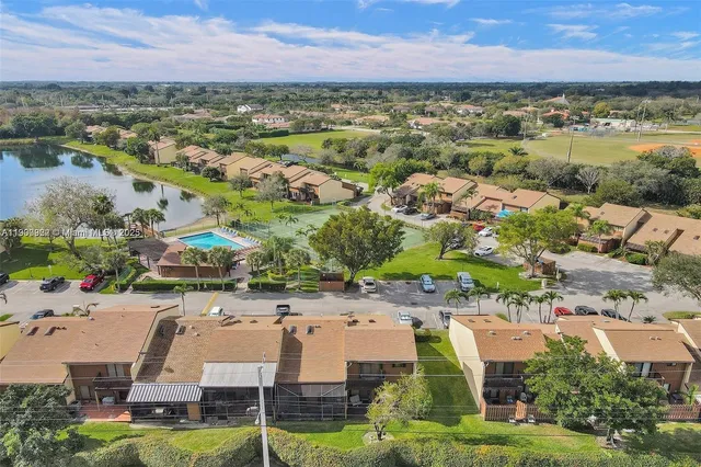 an aerial view of residential houses with outdoor space