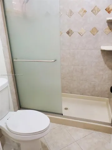 a bathroom with a toilet and a bath tub