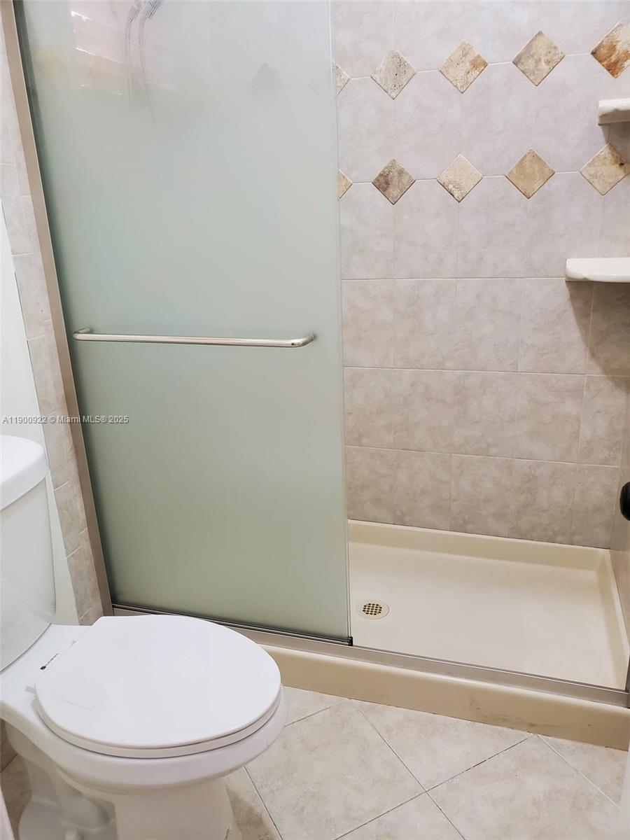 4206 Southwest 87th Terrace, Unit 4206 Davie, FL 33328 - Photo 21 of 37 a bathroom with a toilet and a bath tub