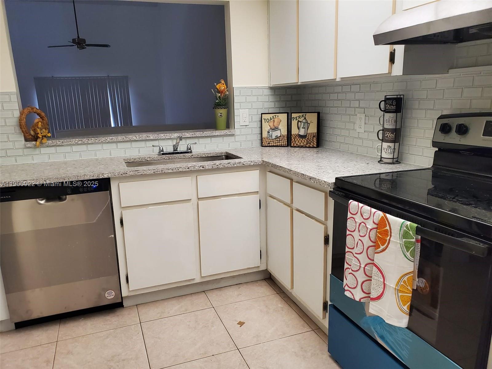 4206 Southwest 87th Terrace, Unit 4206 Davie, FL 33328 - Photo 3 of 37 a kitchen with stainless steel appliances granite countertop a sink stove and cabinets