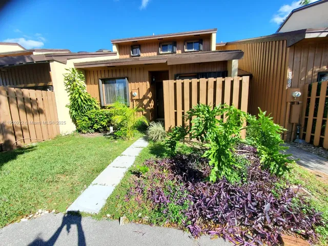 a view of a house with a small yard and plants
