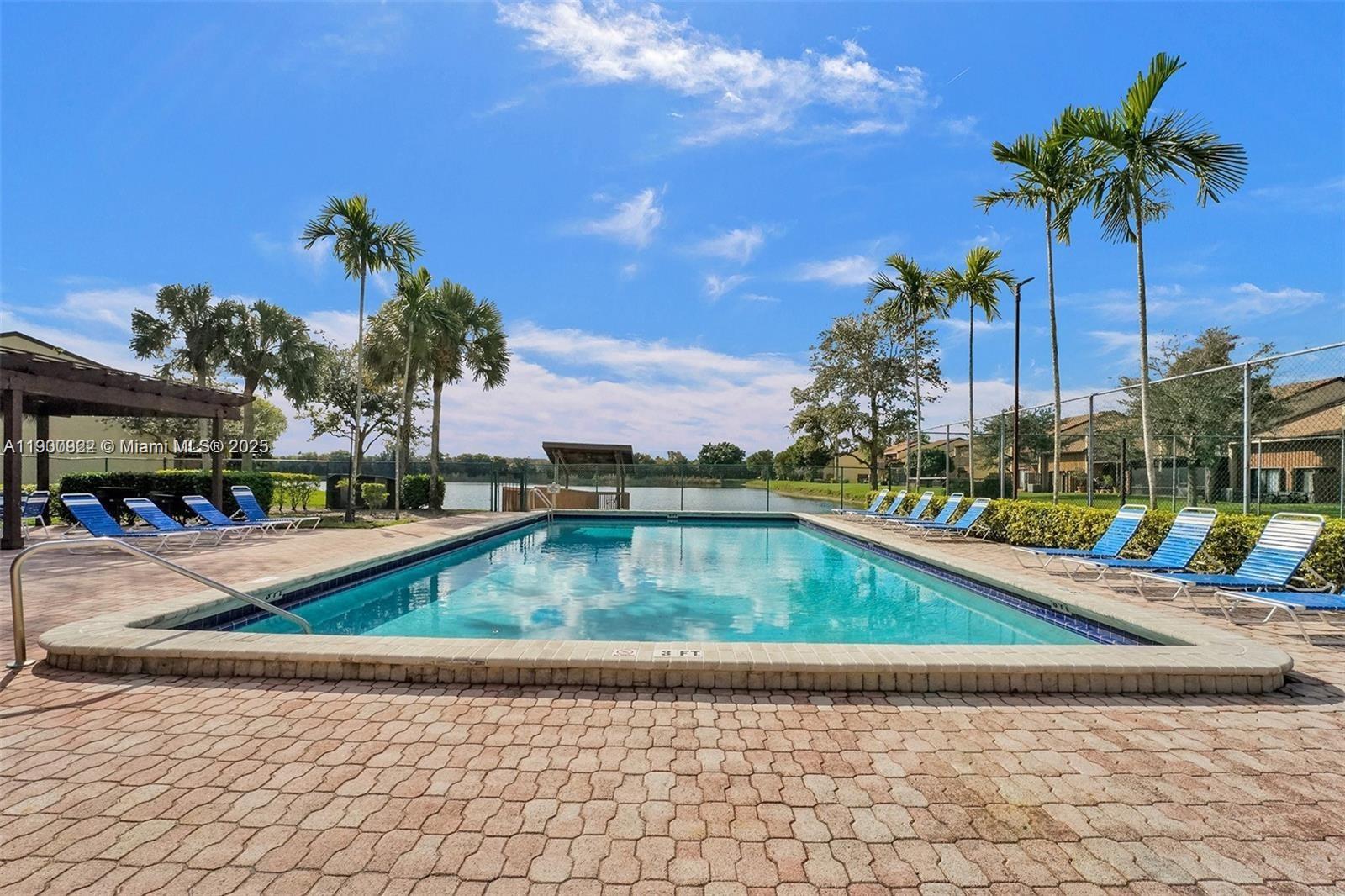 4206 Southwest 87th Terrace, Unit 4206 Davie, FL 33328 - Photo 35 of 37 a view of a swimming pool with a lounge chair