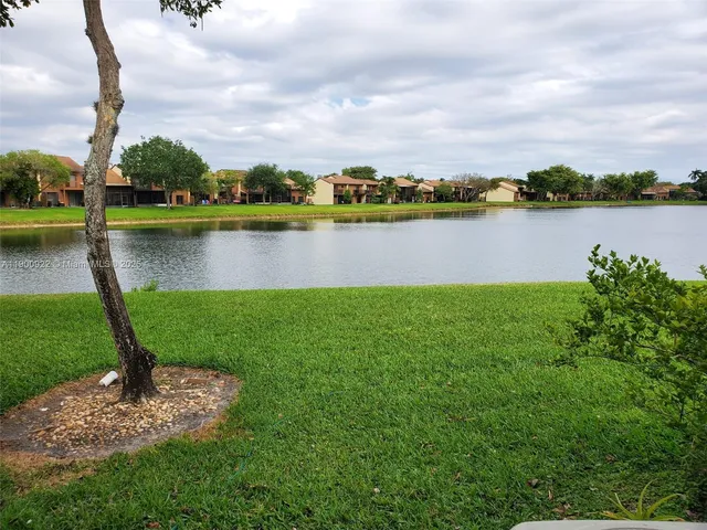 a view of a lake with houses in the back