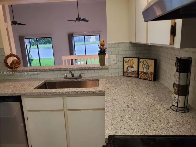 a kitchen with a sink and a refrigerator