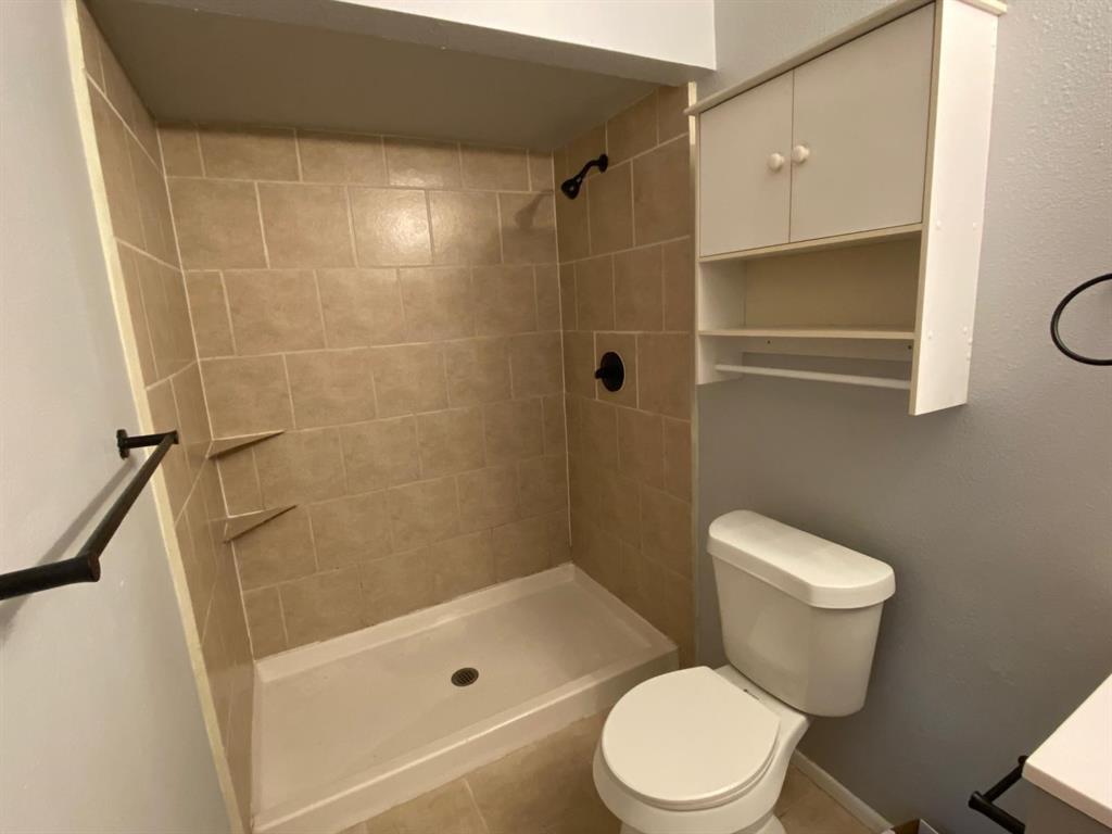 5217 Kisor Drive The Colony, TX 75056 - Photo 12 of 15 a white toilet sitting next to a bathroom