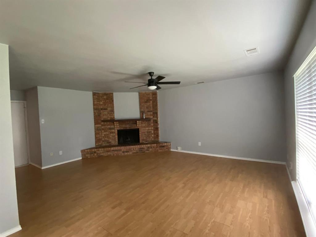 5217 Kisor Drive The Colony, TX 75056 - Photo 3 of 15 an empty room with windows and fireplace