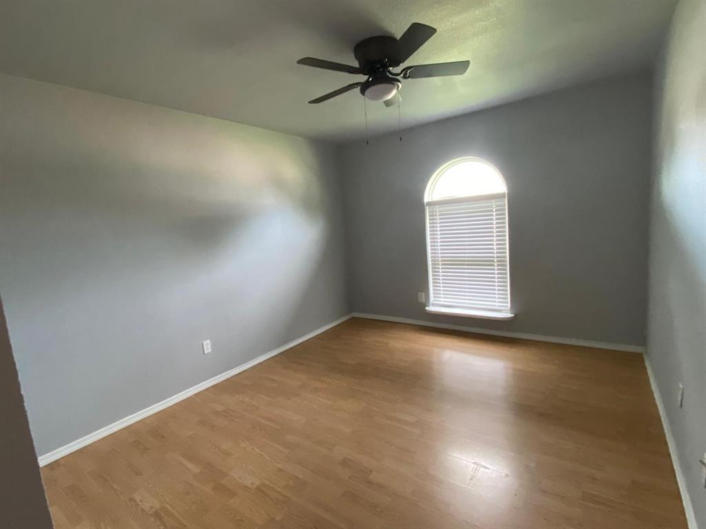 5217 Kisor Drive The Colony, TX 75056 - Photo 7 of 15 an empty room with a window and a fan