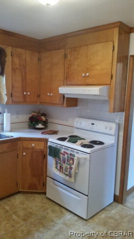 292 Evans Road Mathews, VA 23109 - Photo 11 of 37 a white stove top oven sitting inside of a kitchen