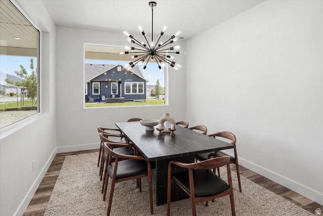 1315 West 3200 South, Unit 17 Perry, UT 84302 - Photo 10 of 58 Dining area featuring a contemporary sputnik chandelier, wood-finish flooring, and a large window