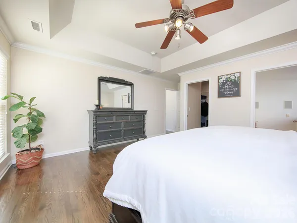 a hallway with a granite countertop sink and a mirror