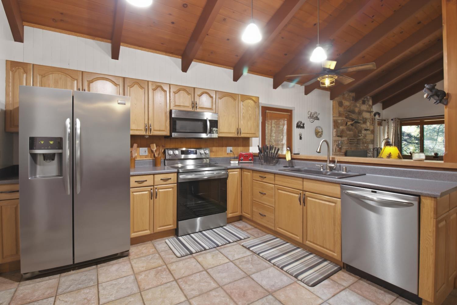 4599 Rivendale Road Placerville, CA 95667 - Photo 6 of 27 a kitchen with stainless steel appliances granite countertop a refrigerator and a sink