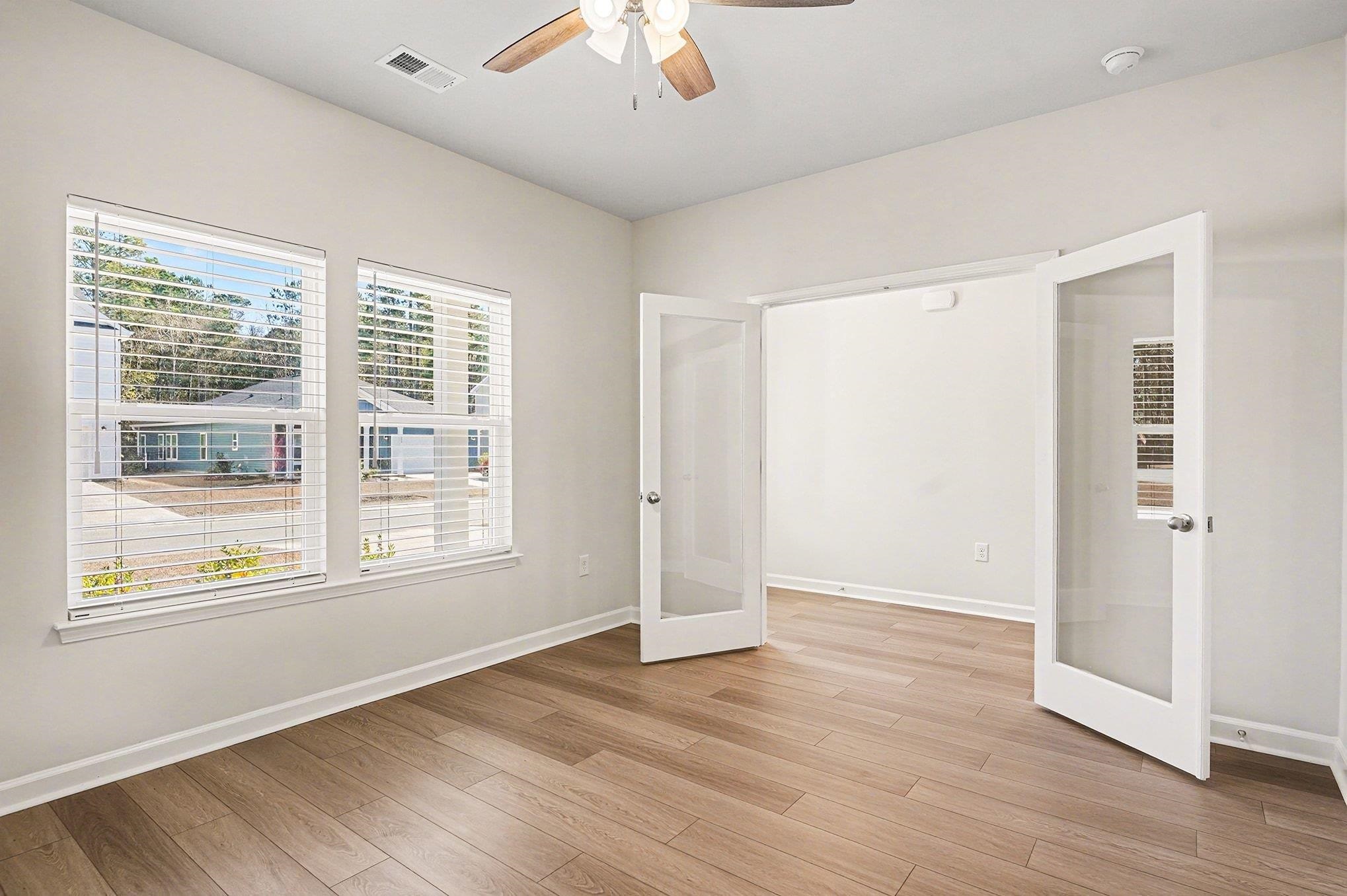 3005 Palma Way Myrtle Beach, SC 29579 - Photo 9 of 30 Unfurnished room featuring french doors, light wood-style floors, and a ceiling fan