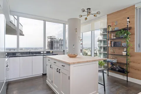 a kitchen with a sink stove and chairs