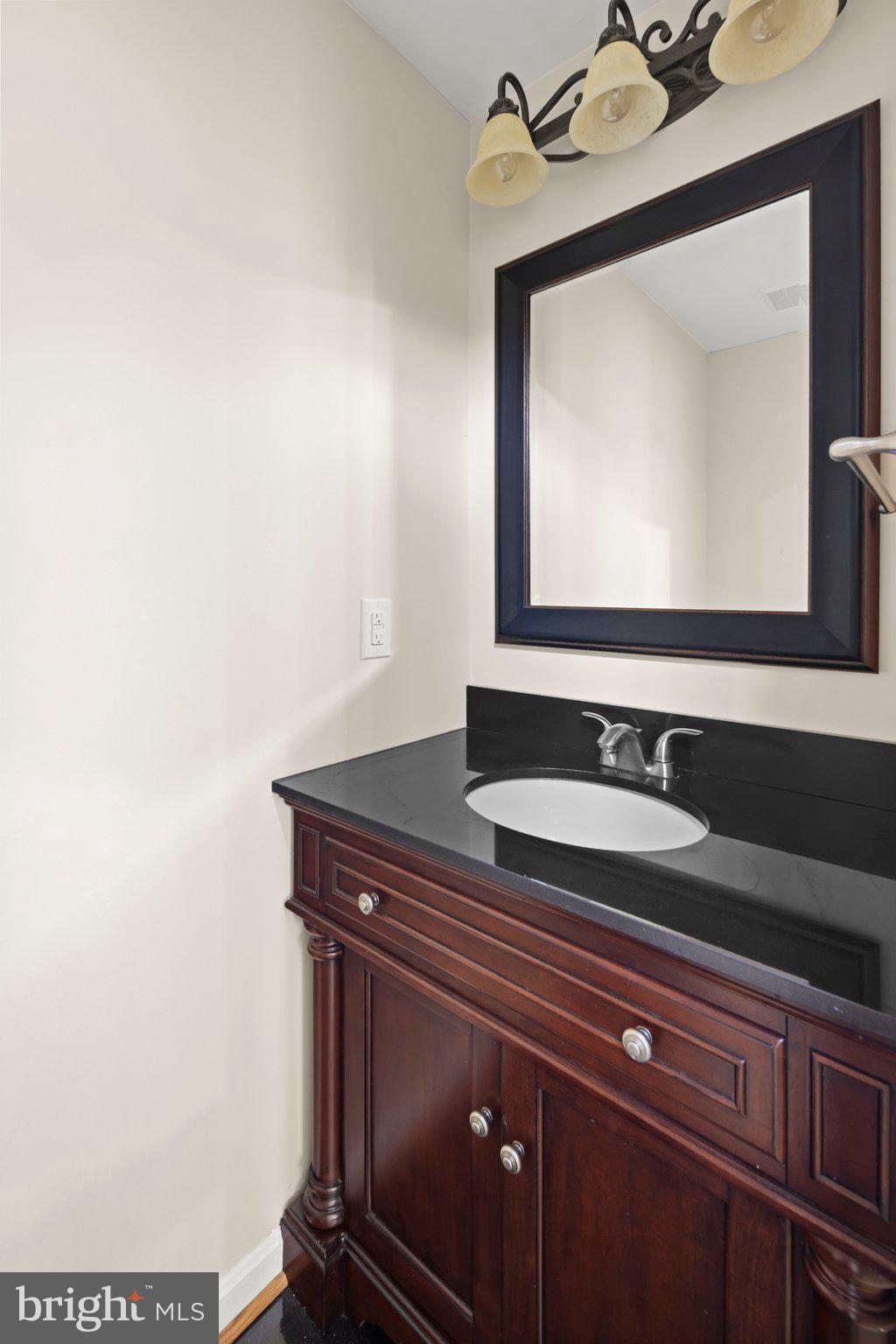 1451 Bluemont Court Herndon, VA 20170 - Photo 12 of 33 a bathroom with a sink and a mirror