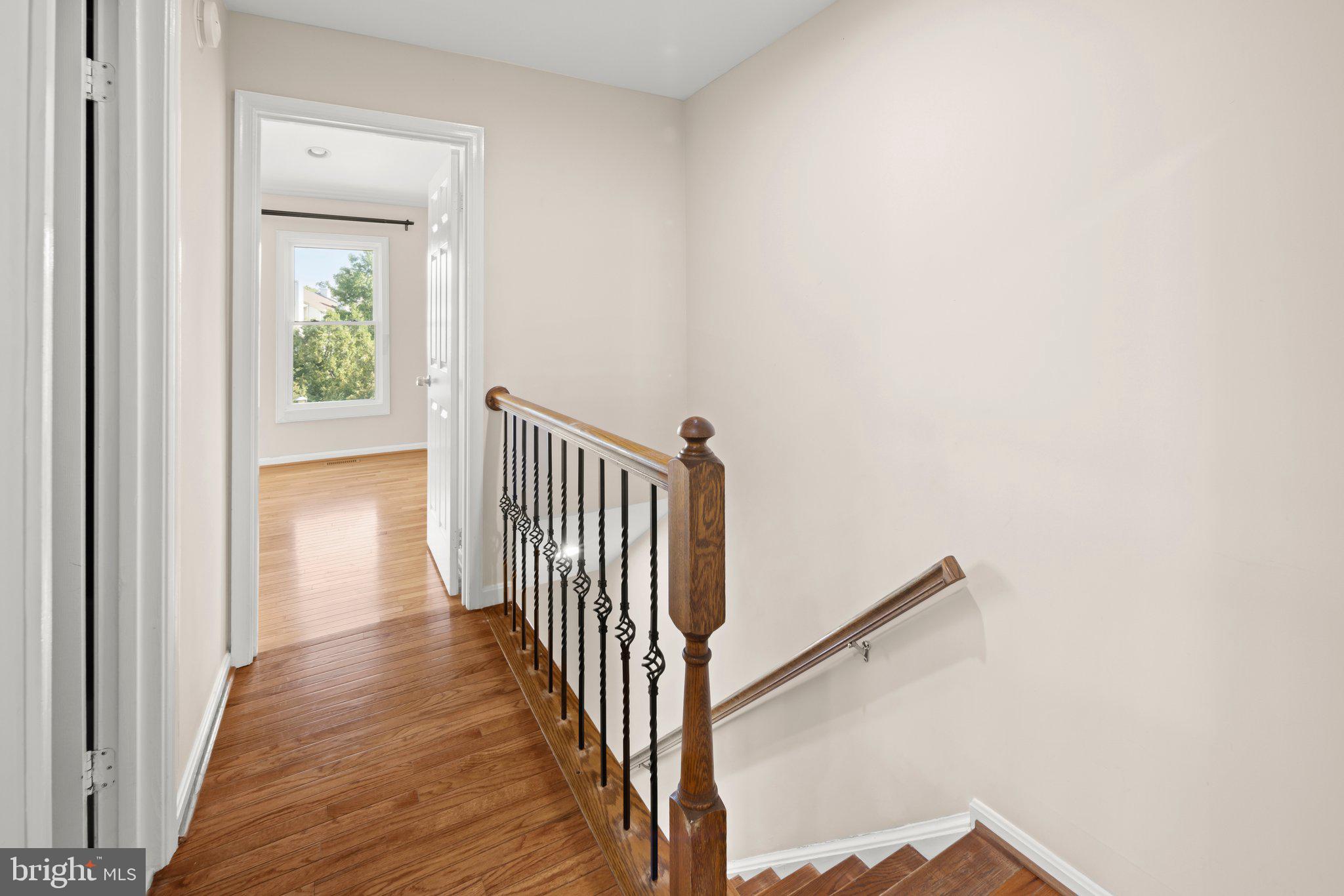 1451 Bluemont Court Herndon, VA 20170 - Photo 15 of 33 a view of a hallway with wooden floor