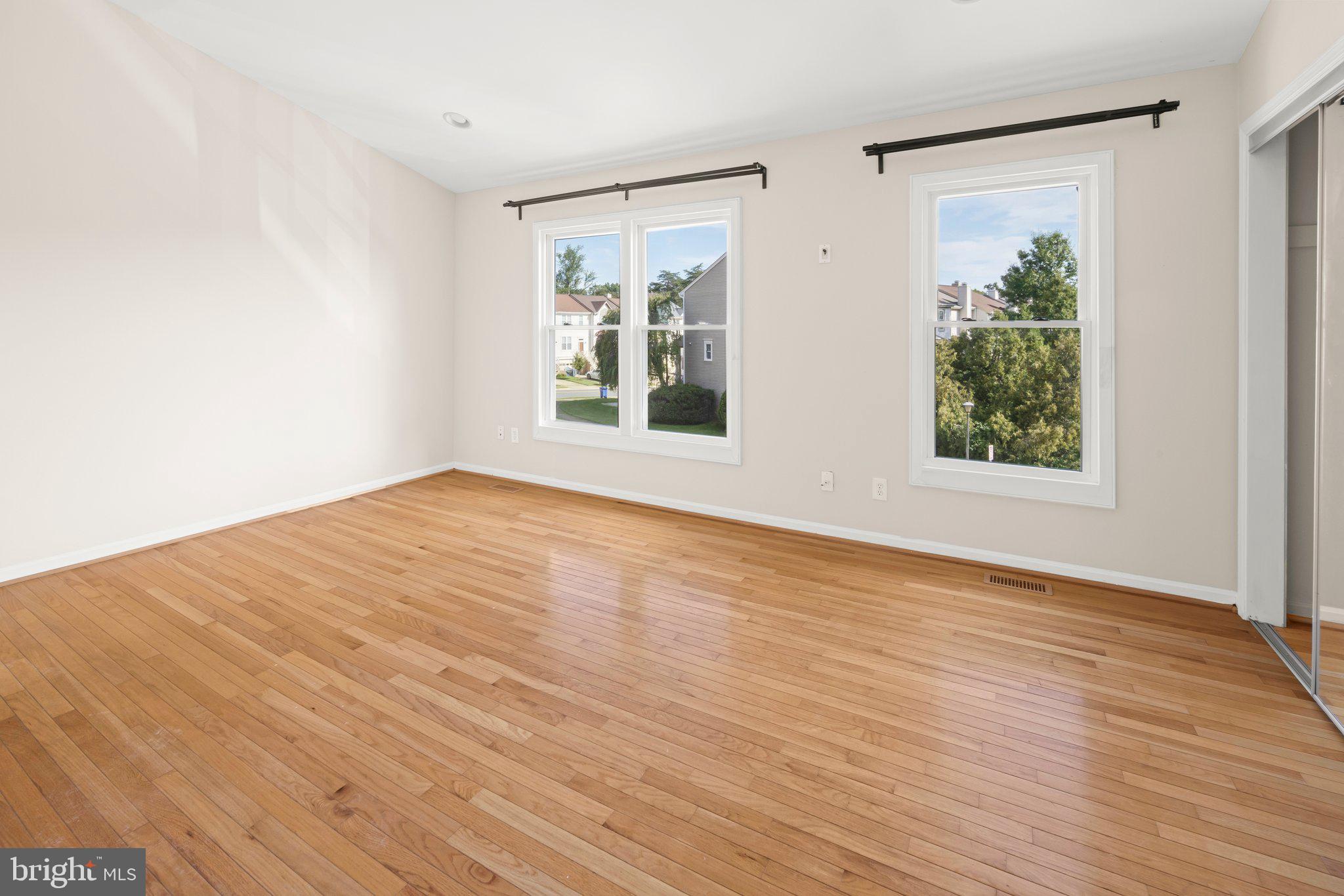 1451 Bluemont Court Herndon, VA 20170 - Photo 17 of 33 a view of an empty room with wooden floor and a window
