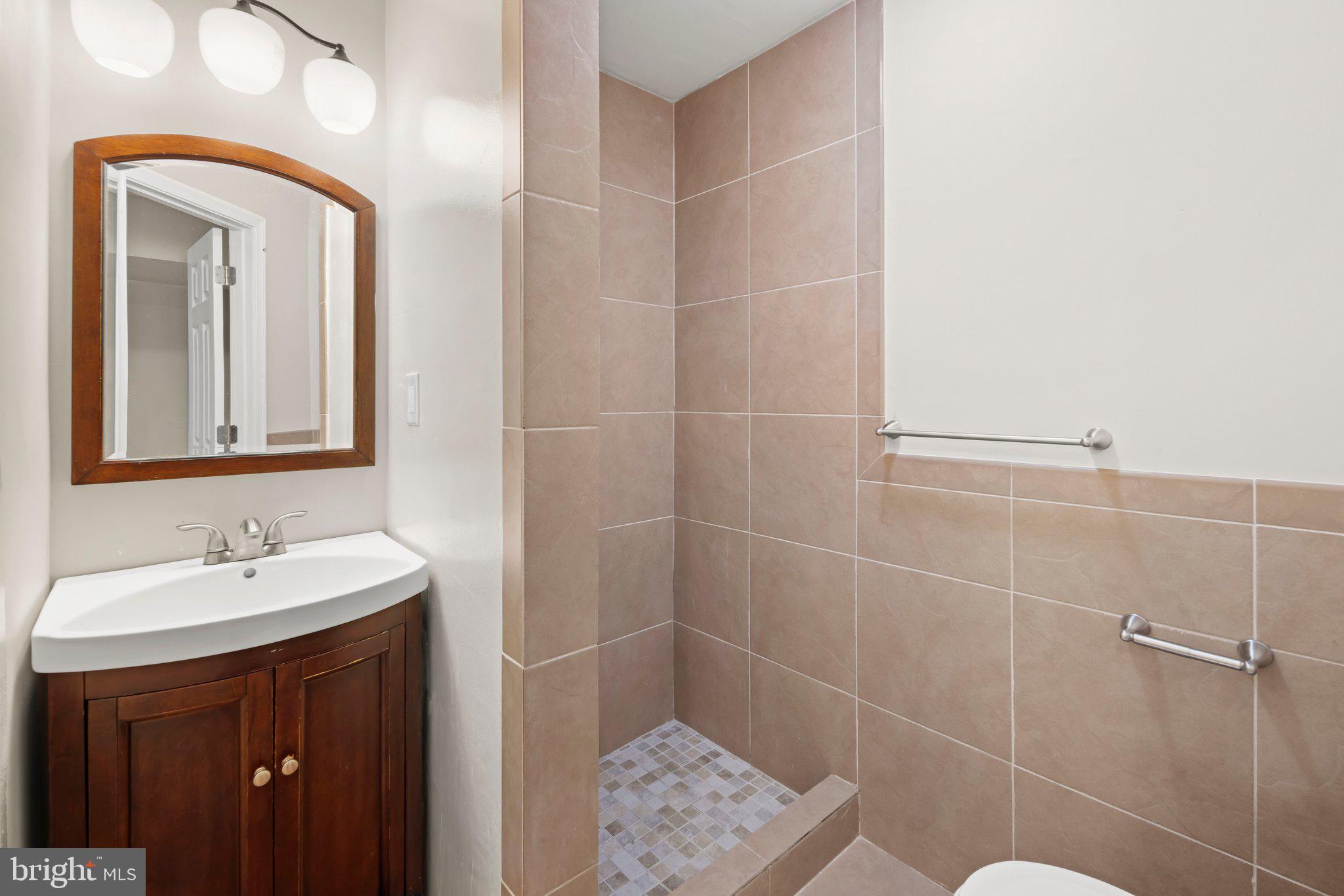 1451 Bluemont Court Herndon, VA 20170 - Photo 25 of 33 a bathroom with a sink a toilet and a mirror