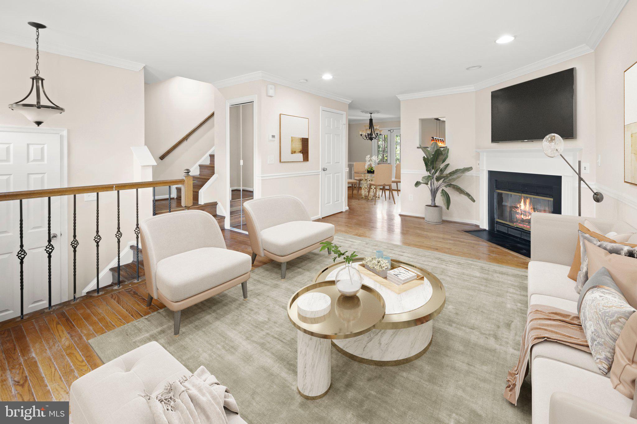 1451 Bluemont Court Herndon, VA 20170 - Photo 3 of 33 a living room with furniture a fireplace and a flat screen tv