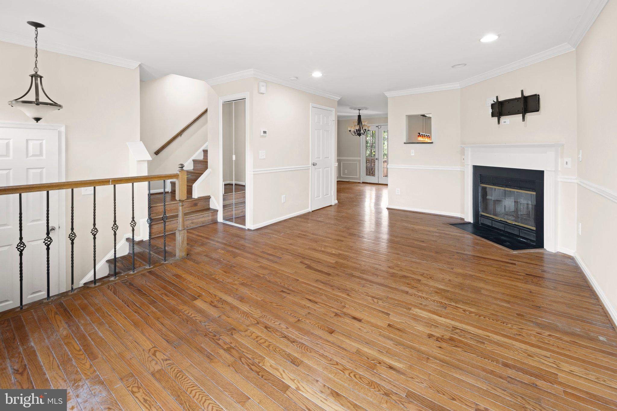 1451 Bluemont Court Herndon, VA 20170 - Photo 4 of 33 a view of a livingroom with wooden floor and a fireplace