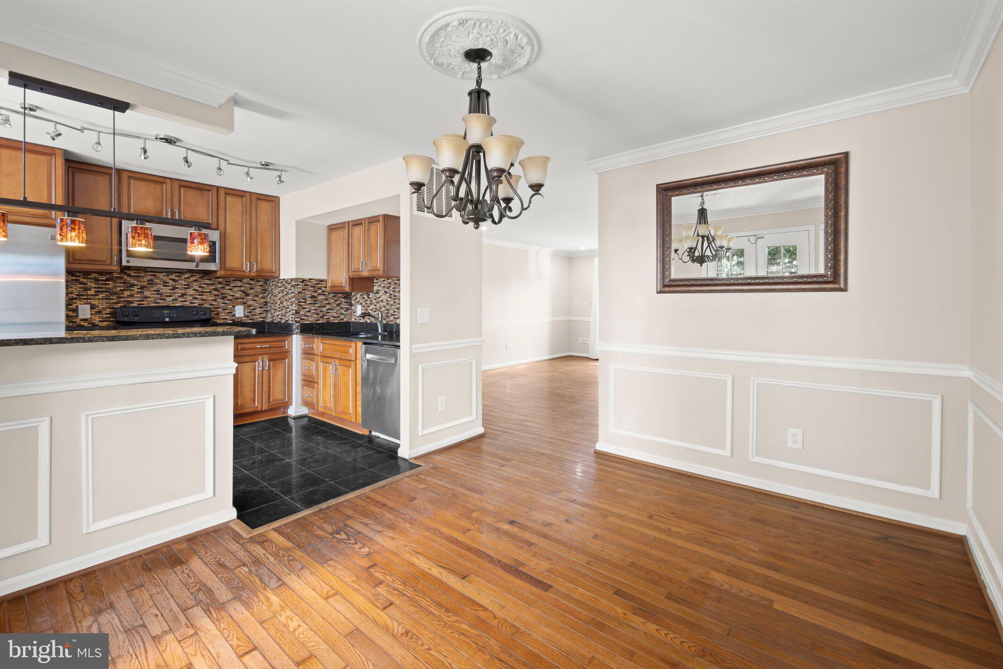 1451 Bluemont Court Herndon, VA 20170 - Photo 7 of 33 a view of a kitchen with wooden floor and a window