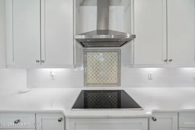 a kitchen with a stove and a white cabinet