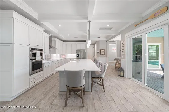 a large kitchen with a table and chairs