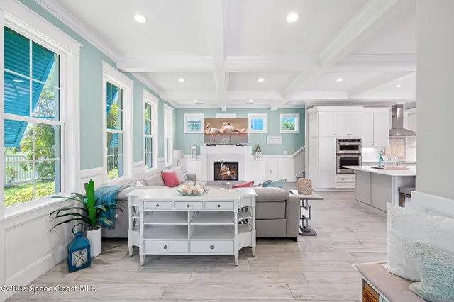 a living room with furniture a fireplace and a table