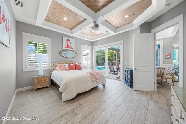 a bedroom with a bed and a large window with the outer view