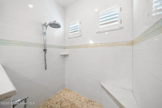 a bathroom with double vanity sink and a mirror