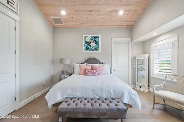 a bedroom with a large bed and furniture