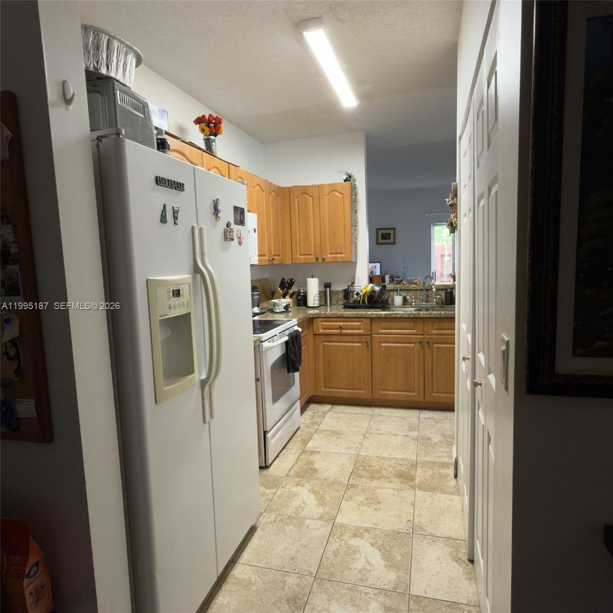 16029 Emerald Cove Road Weston, FL 33331 - Photo 11 of 20 a utility room with cabinets washer and dryer