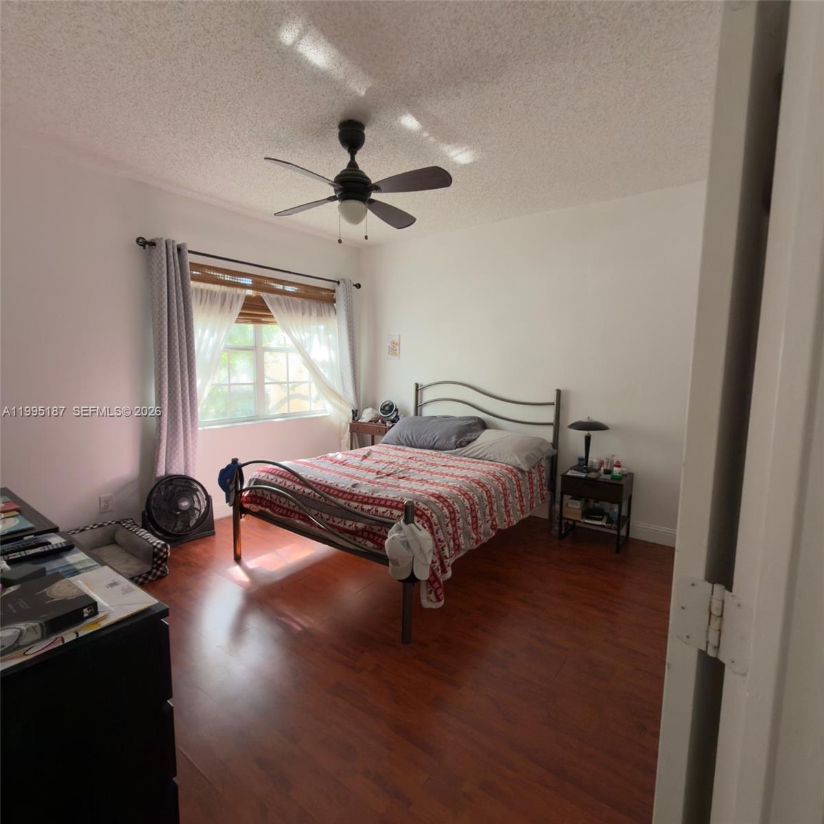 16029 Emerald Cove Road Weston, FL 33331 - Photo 14 of 20 a bedroom with a bed and a chandelier