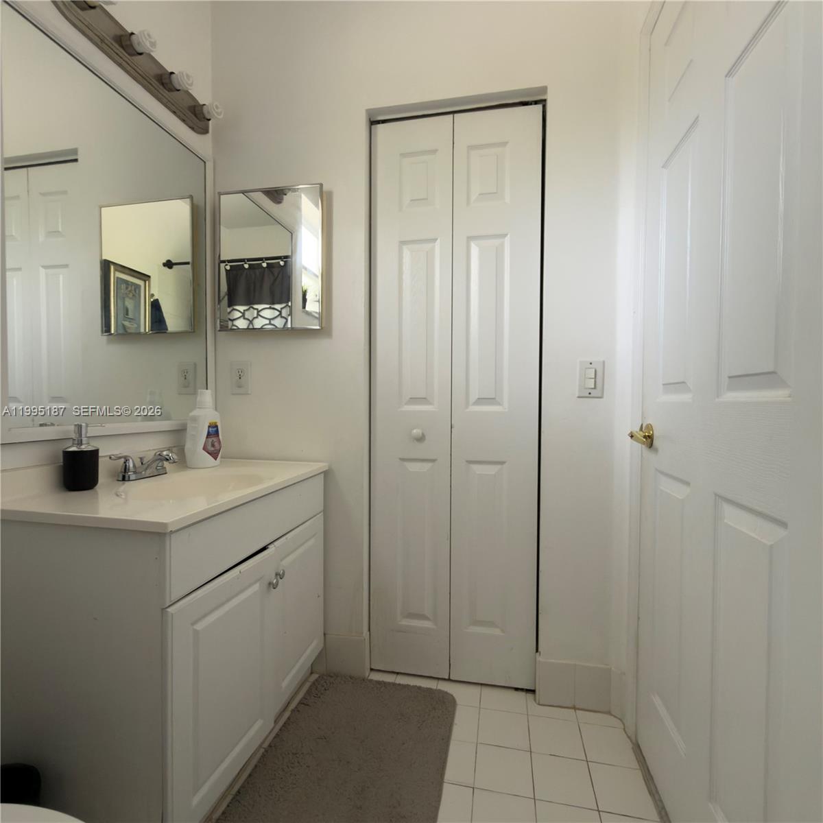 16029 Emerald Cove Road Weston, FL 33331 - Photo 16 of 20 a bathroom with a sink a mirror and shower