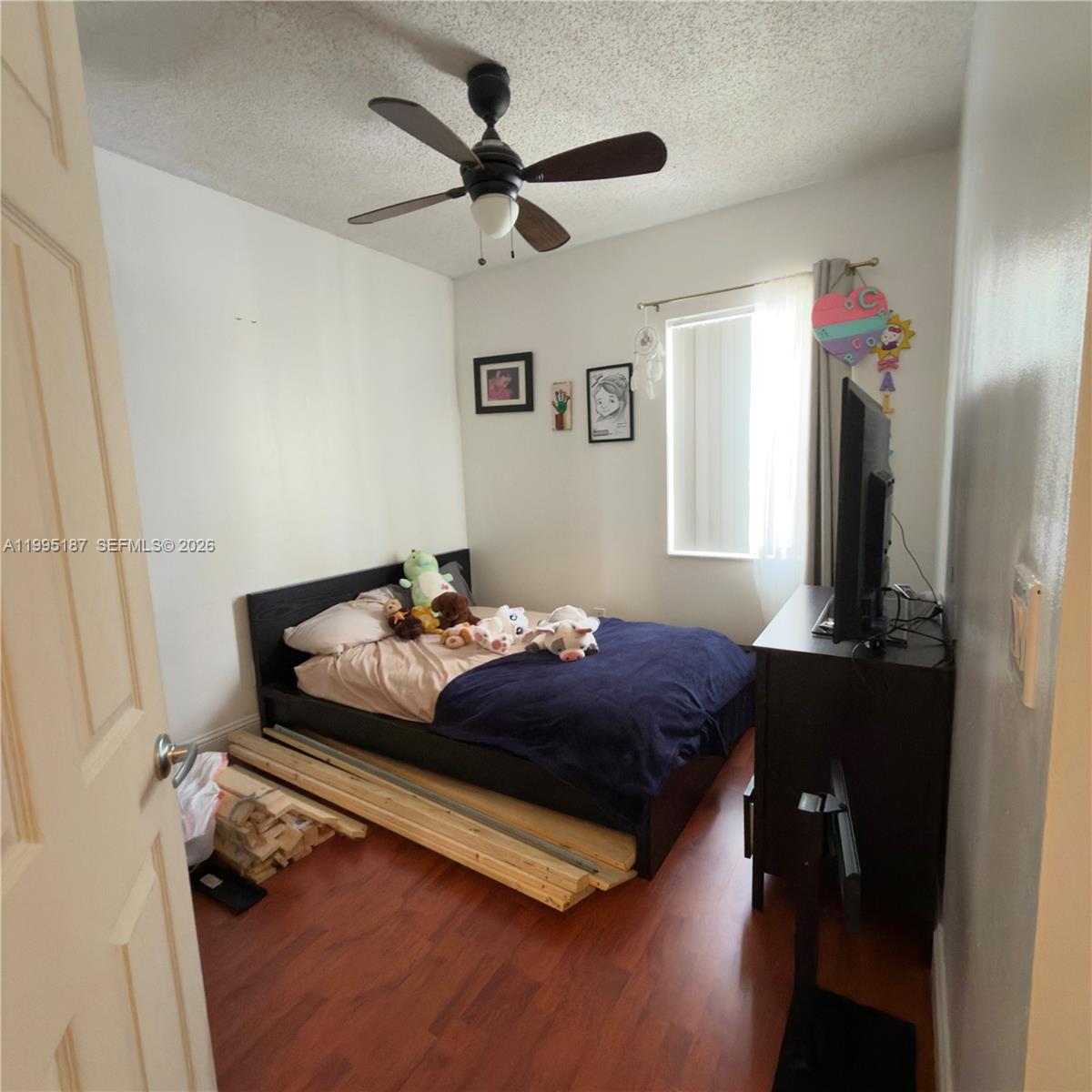 16029 Emerald Cove Road Weston, FL 33331 - Photo 20 of 20 a bedroom with a bed dresser and a window