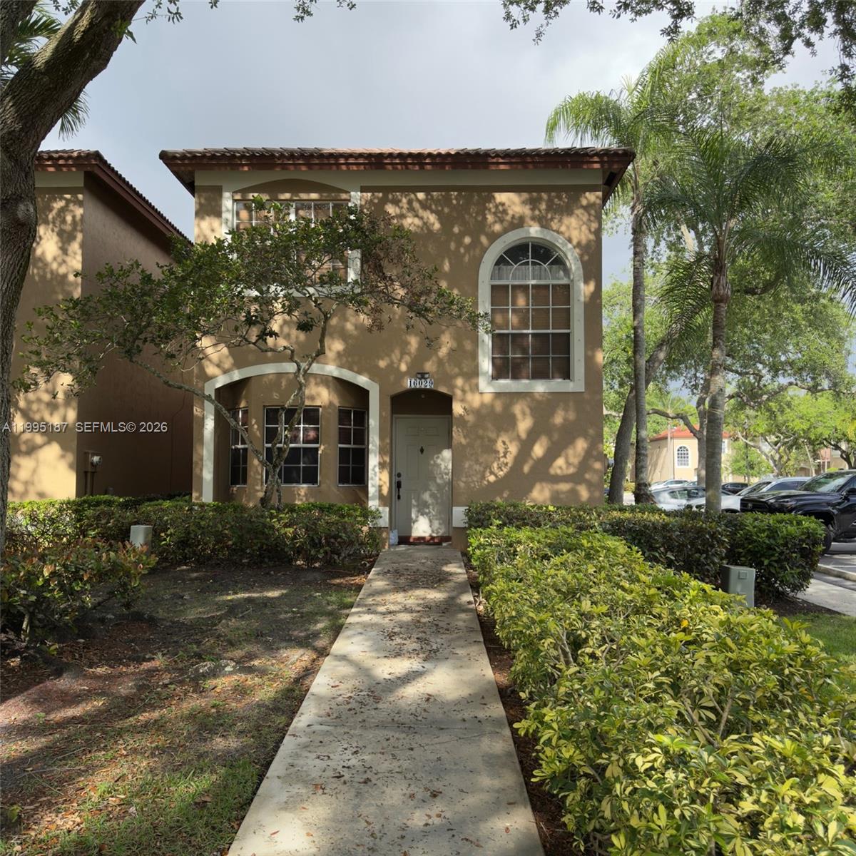 16029 Emerald Cove Road Weston, FL 33331 - Photo 2 of 20 front view of a house with a yard