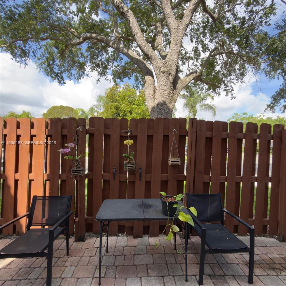 16029 Emerald Cove Road Weston, FL 33331 - Photo 8 of 20 a view of a chairs and table in a backyard