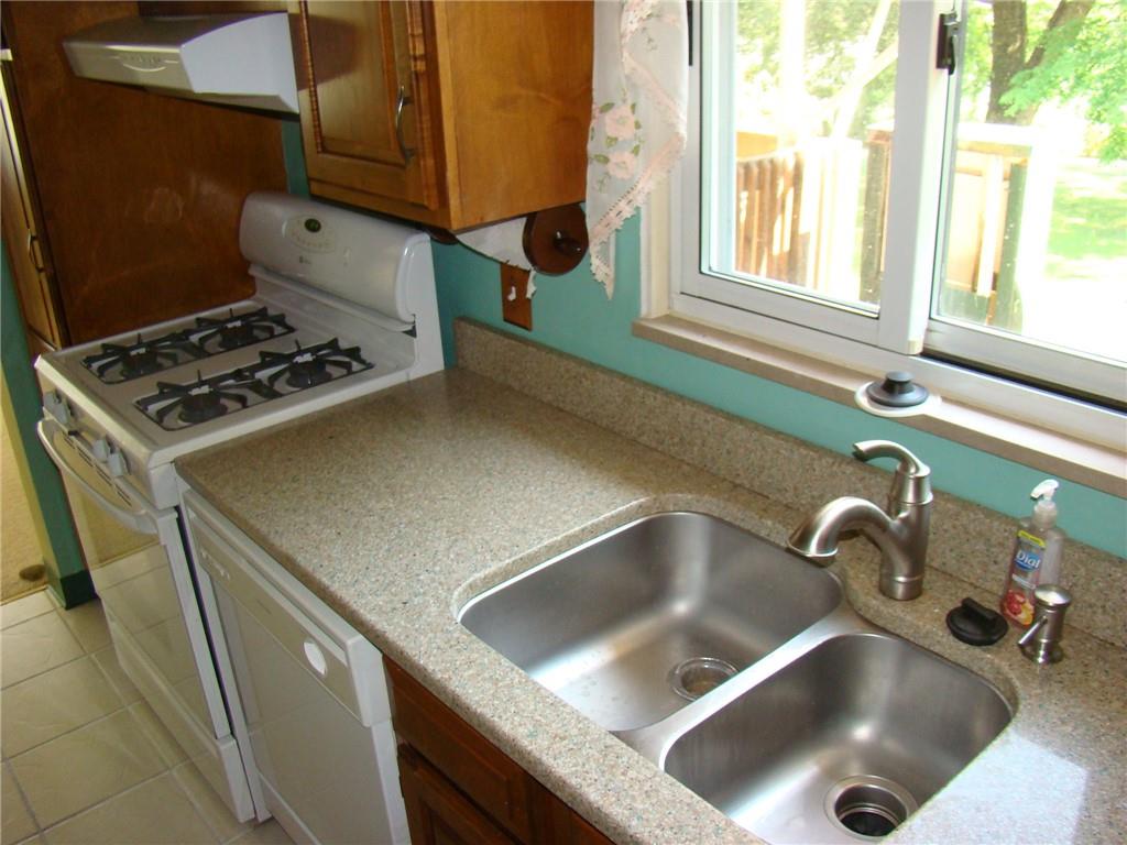 220 McGregor Drive Verona, PA 15147 - Photo 11 of 25 a kitchen with a sink and a stove next to a window