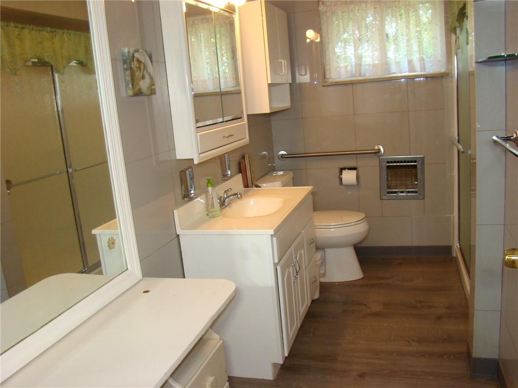 220 McGregor Drive Verona, PA 15147 - Photo 13 of 25 a bathroom with a sink a toilet and shower