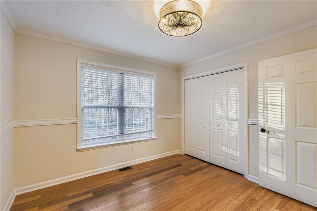 16 Inland Point Newnan, GA 30263 - Photo 15 of 34 an empty room with wooden floor and windows