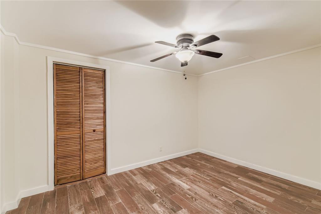 16 Inland Point Newnan, GA 30263 - Photo 20 of 34 an empty room with wooden floor fan and windows